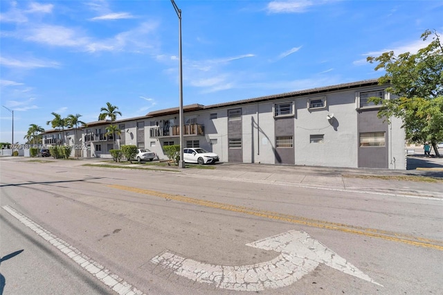 view of property featuring a residential view and uncovered parking