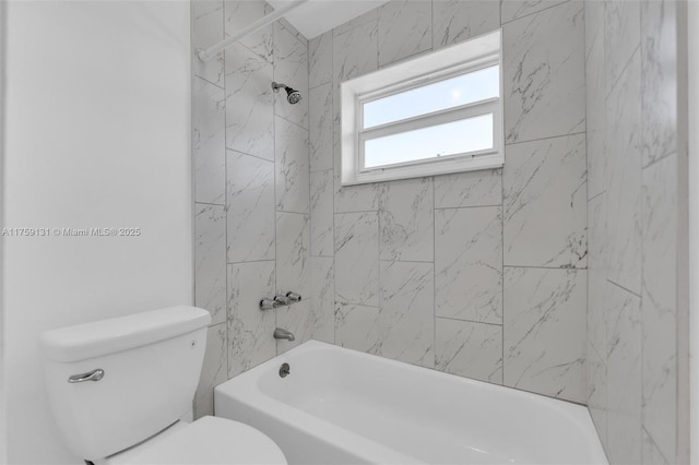 bathroom featuring tub / shower combination and toilet