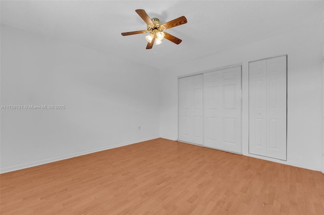 unfurnished bedroom featuring baseboards, ceiling fan, and light wood finished floors