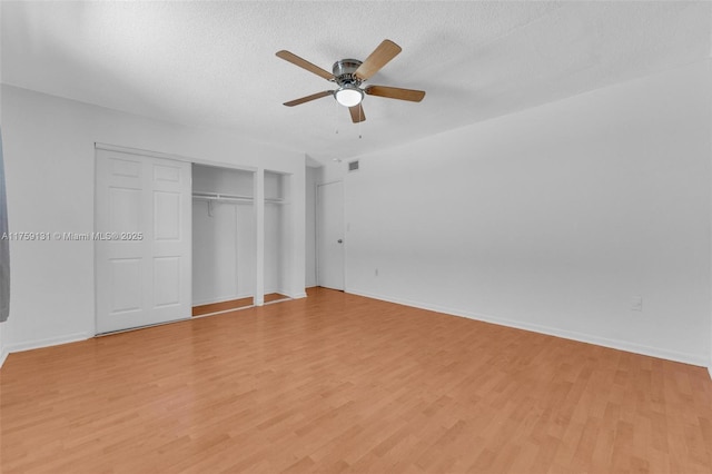 unfurnished bedroom with light wood-style flooring, visible vents, and a textured ceiling