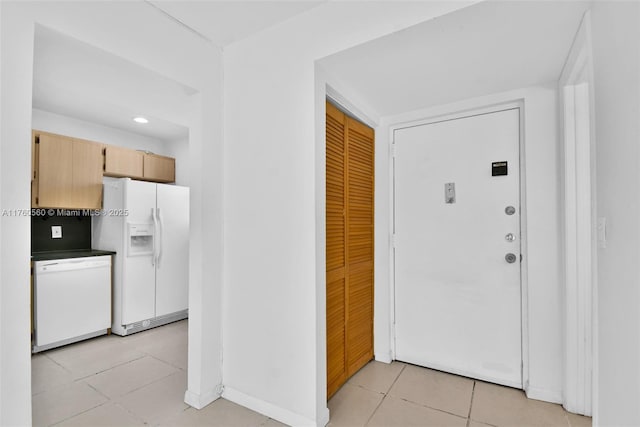 618 Euclid Ave Unit 303, Miami Beach, FL 33139 - kitchen with white appliances, light brown cabinets, and light tile patterned floors