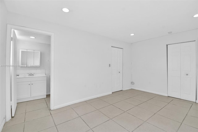 618 Euclid Ave Unit 303, Miami Beach, FL 33139 - unfurnished bedroom featuring light tile patterned flooring, recessed lighting, and connected bathroom