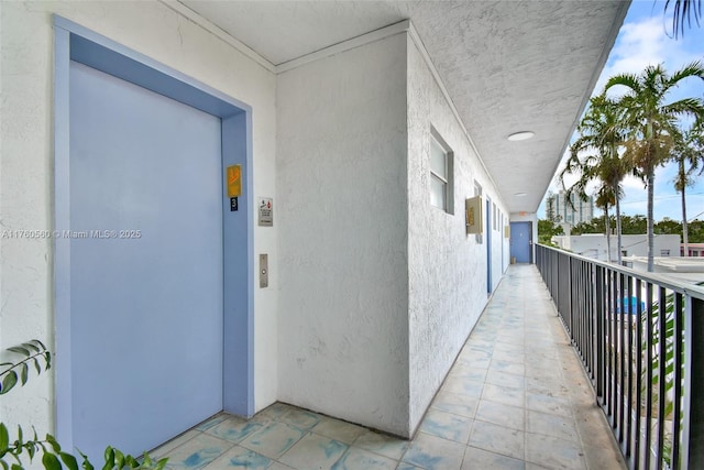 618 Euclid Ave Unit 303, Miami Beach, FL 33139 - view of exterior entry featuring elevator, stucco siding, and a balcony