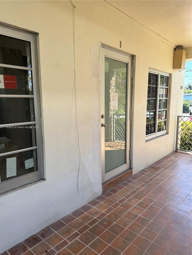 property entrance with stucco siding