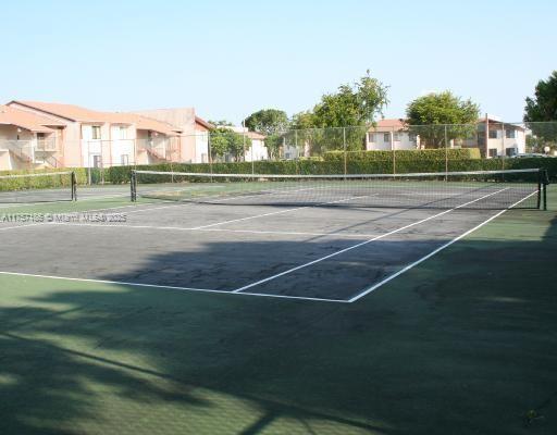 view of tennis court with fence