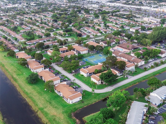 birds eye view of property with a water view and a residential view