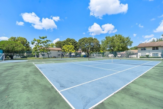 view of tennis court with fence