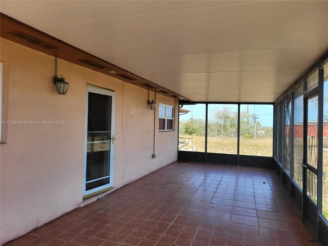 unfurnished sunroom with visible vents