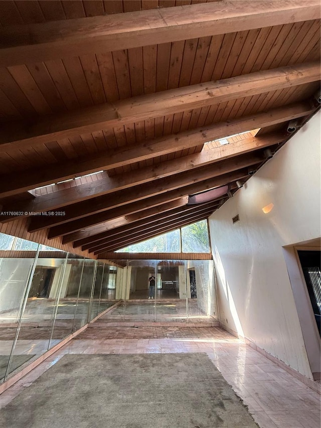 interior space featuring wood ceiling and lofted ceiling with beams