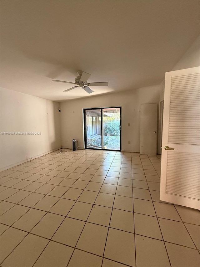 unfurnished room with light tile patterned flooring and a ceiling fan