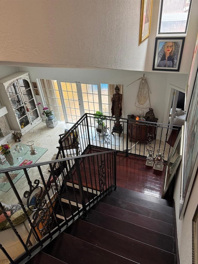 1838 NW 93rd Ter, Plantation, FL 33322 - stairs featuring a textured wall and wood-type flooring