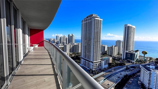 balcony with a view of city and a water view