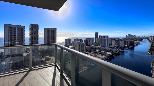 balcony featuring a water view and a view of city