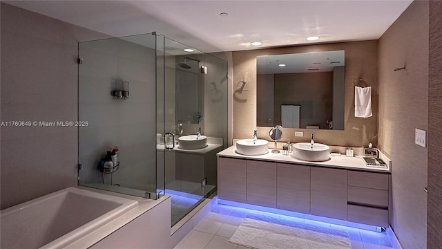 bathroom with tile patterned floors, a stall shower, vanity, and a bath