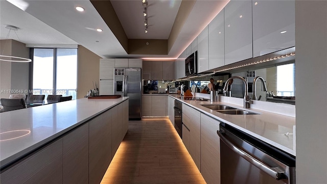 2600 E Hallandale Beach Blvd Unit T3101, Hallandale Beach, FL 33009 - kitchen featuring black appliances, a sink, modern cabinets, rail lighting, and wood finished floors