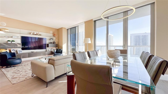 dining space with expansive windows and wood finished floors