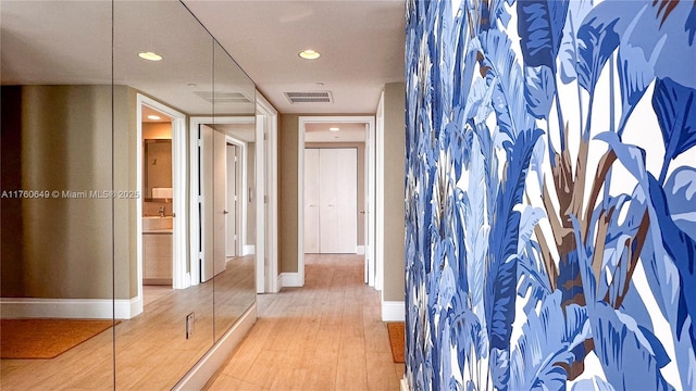 hallway featuring recessed lighting, wood finished floors, visible vents, and baseboards