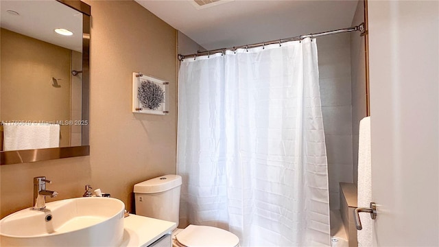 bathroom featuring shower / tub combo with curtain, vanity, and toilet