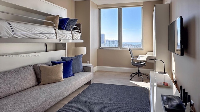 bedroom with wood finished floors and baseboards