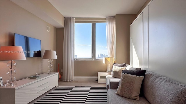 sitting room with light wood-style flooring and baseboards