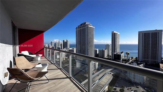 balcony featuring a view of city and a water view