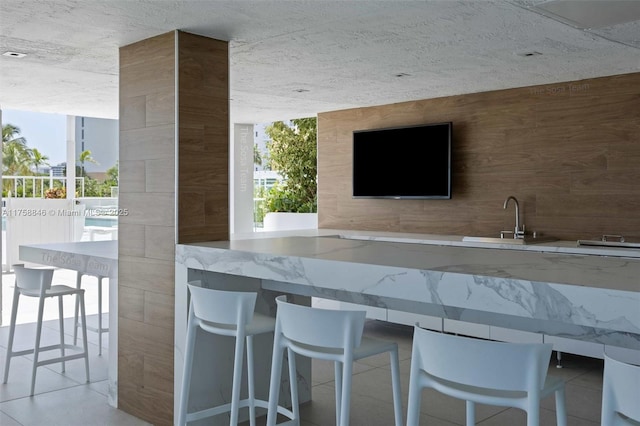 770 Claughton Island Dr Unit Ph-18, Miami, FL 33131 - bar with tile patterned floors, a wall of windows, and a sink