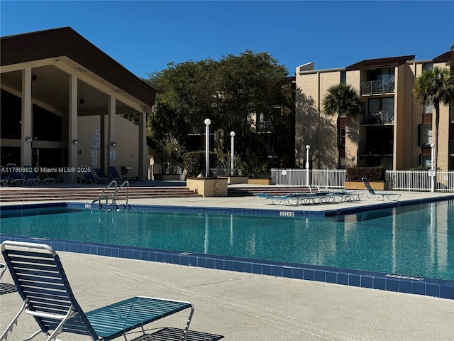 pool featuring a patio area and fence