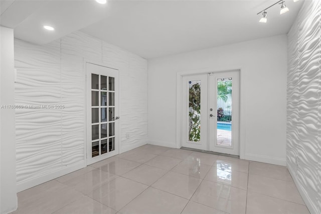 interior space with tile patterned flooring, recessed lighting, french doors, and baseboards