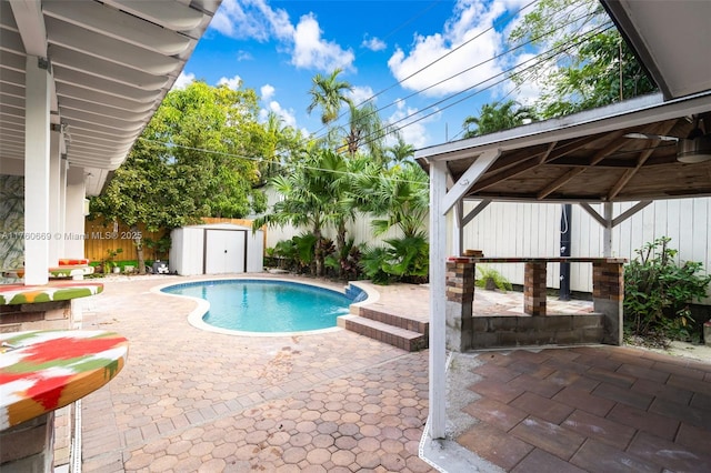 view of pool with a gazebo, a storage shed, a fenced backyard, an outdoor structure, and a patio