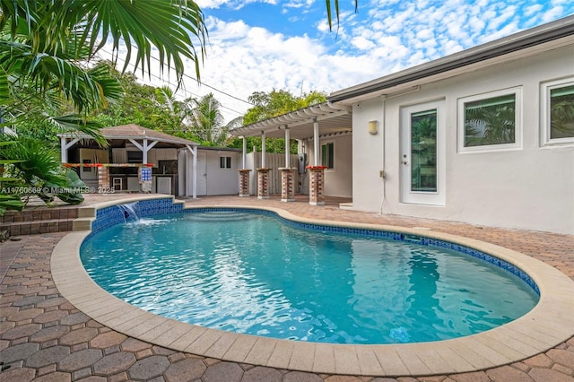 pool featuring a patio, an outbuilding, outdoor dry bar, and fence