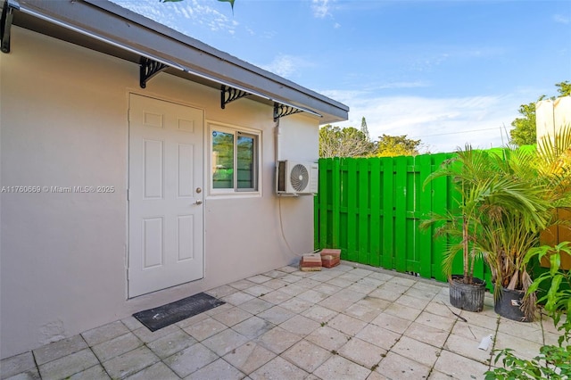 exterior space featuring ac unit and fence