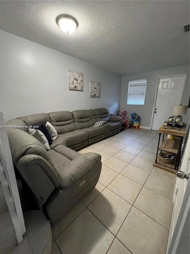 living room featuring light tile patterned floors and a textured ceiling