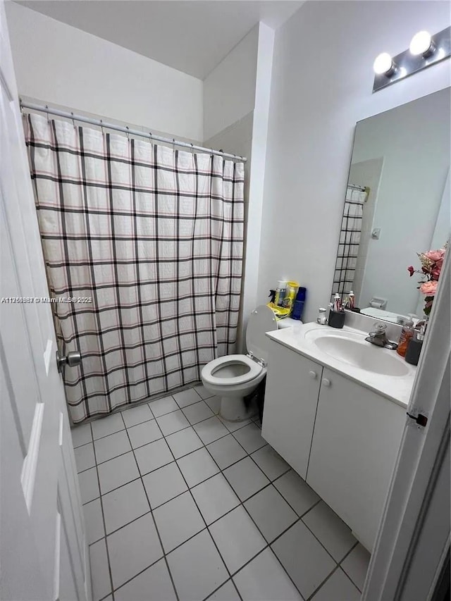 bathroom featuring tile patterned flooring, toilet, curtained shower, and vanity