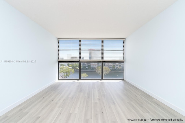 200 Leslie Dr Unit 430, Hallandale Beach, FL 33009 - unfurnished room featuring expansive windows, wood finished floors, and baseboards