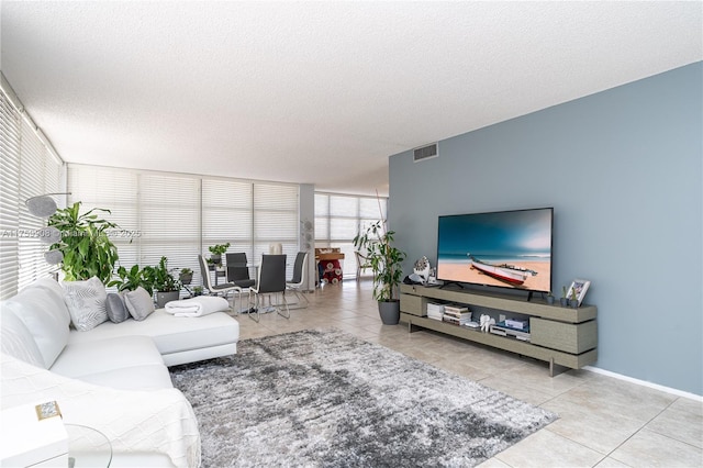 200 Leslie Dr Unit 430, Hallandale Beach, FL 33009 - tiled living room featuring a textured ceiling and baseboards