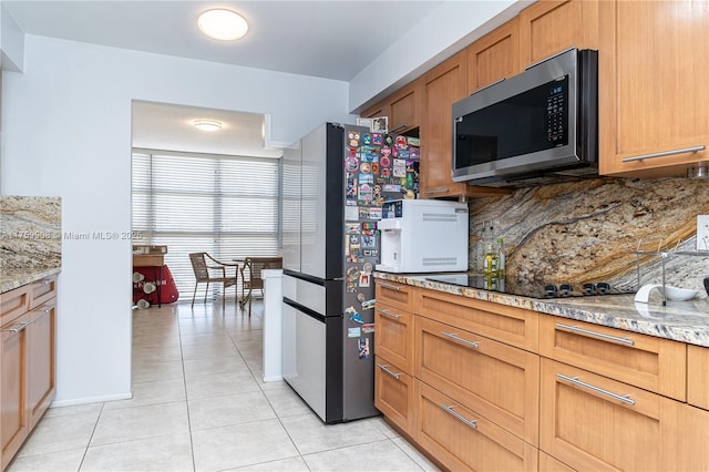 200 Leslie Dr Unit 430, Hallandale Beach, FL 33009 - kitchen featuring stainless steel appliances, light tile patterned floors, tasteful backsplash, and light stone countertops