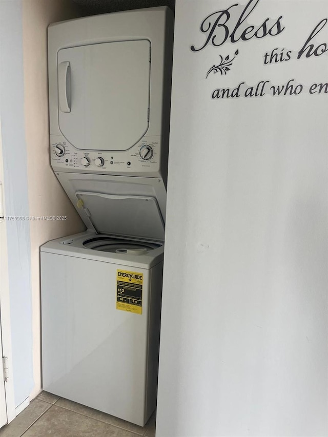 200 Leslie Dr Unit 430, Hallandale Beach, FL 33009 - washroom with stacked washing machine and dryer and light tile patterned floors