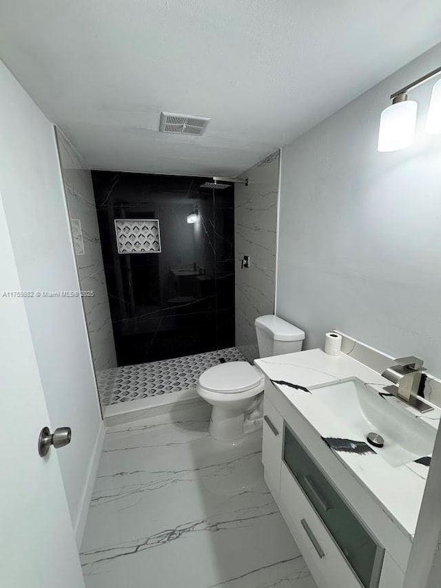 bathroom featuring tiled shower, marble finish floor, toilet, and visible vents