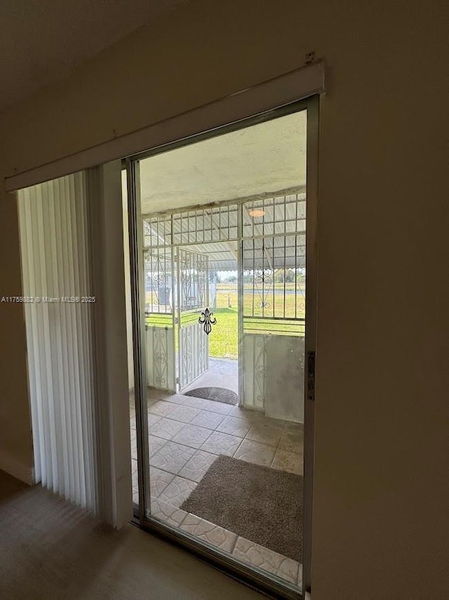 doorway with tile patterned flooring