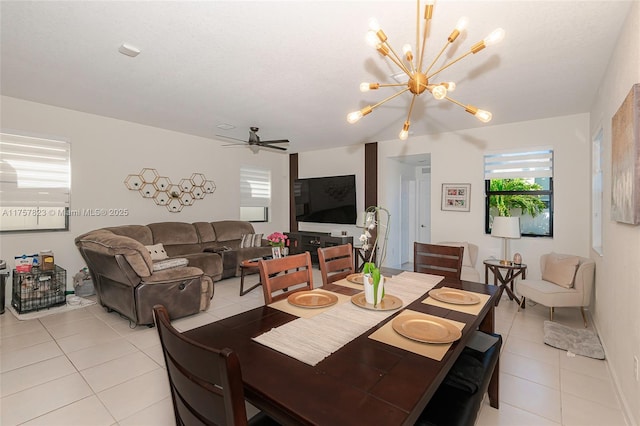 dining area featuring light tile patterned floors and ceiling fan with notable chandelier