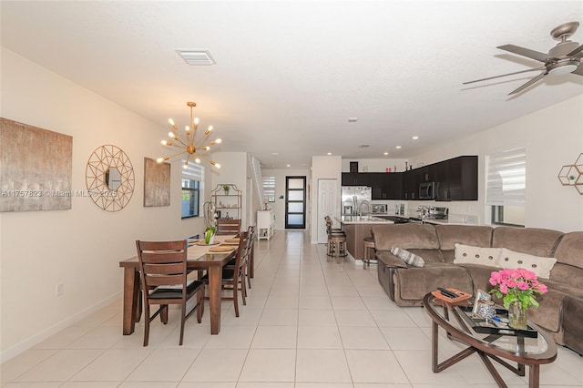 dining room with light tile patterned floors, visible vents, and plenty of natural light