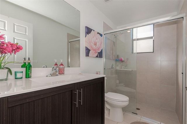 bathroom featuring tile patterned floors, vanity, toilet, and a shower stall