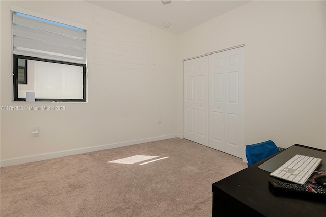 unfurnished bedroom featuring a closet, baseboards, and carpet