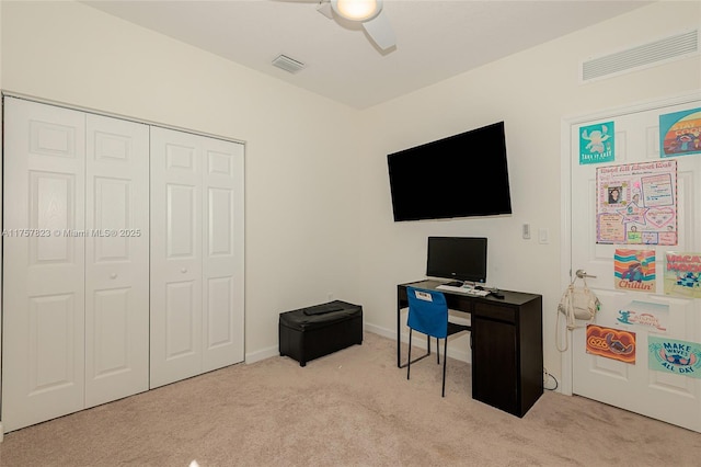 home office featuring a ceiling fan, light colored carpet, and visible vents