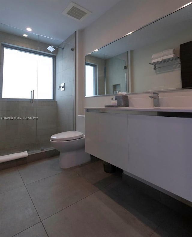 full bath with visible vents, a shower stall, toilet, and vanity