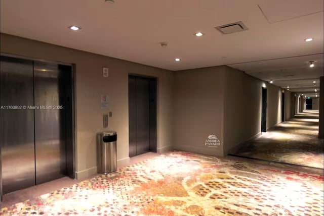 empty room featuring elevator, visible vents, recessed lighting, and baseboards