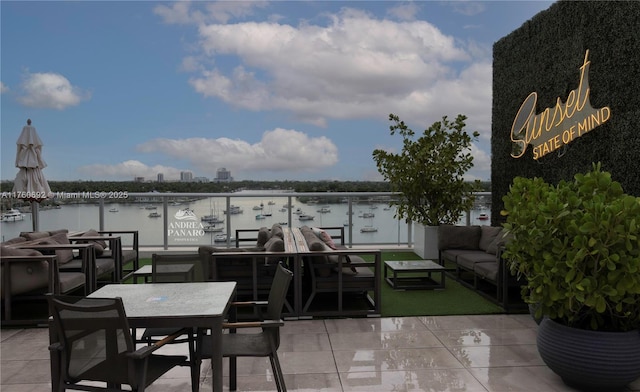 view of patio with outdoor lounge area, outdoor dining area, and a water view