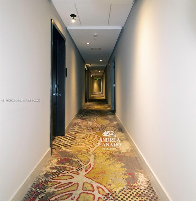 corridor featuring visible vents and baseboards