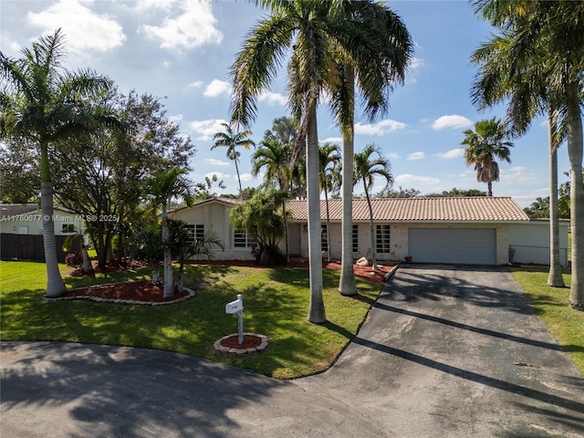 18200 SW 86th Ave, Palmetto Bay, FL 33157 - view of front of home with asphalt driveway, a garage, a tile roof, and a front yard