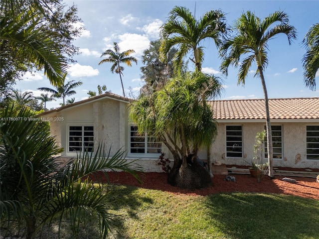 18200 SW 86th Ave, Palmetto Bay, FL 33157 - view of front of house featuring stucco siding, a front yard, and a tiled roof